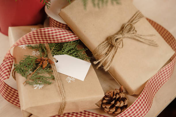 istock Blank Gift tag on Classy vintage Christmas gift box. Christmas presents with handmade decoration. Close up. Mockup. Copy space. 1069637150