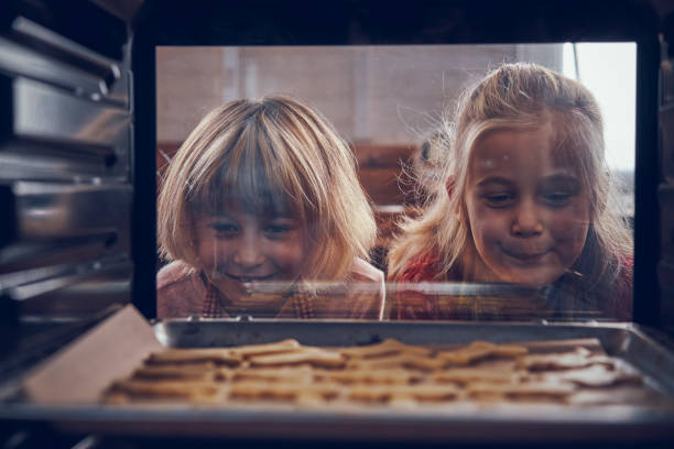 istock Baking Christmas Cookies in the Oven 1069639030