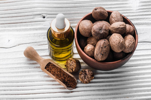 istock nutmeg essential oil on a gray wooden background 1069646892