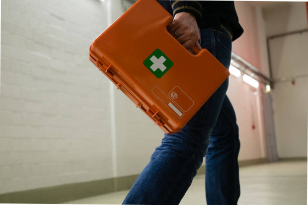 First aid after an accident at work First aid after an accident at work. First responder with first aid kit, Germany. first aid photos stock pictures, royalty-free photos & images