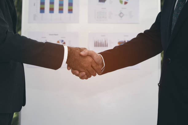 istock handshaking of businessman and partner after agreement complete 1069649756
