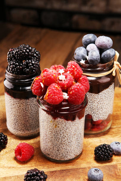 istock Healthy breakfast. chia pudding with kiwi and granola in glass on rustic background. 1069653626