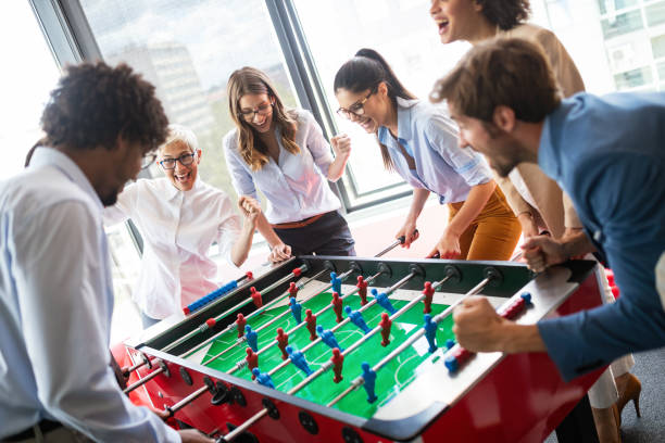 istock Colleagues playing table football in the break. 1069655976