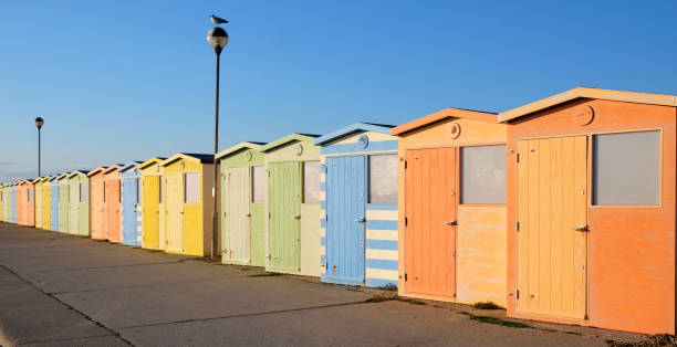 istock a row of twenty bright coloured beach huts with a diminishing perspective 1069656696