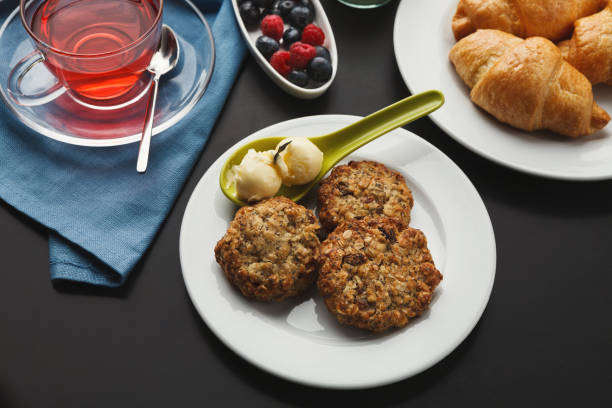 Oatmeal cookies and croissants with tea