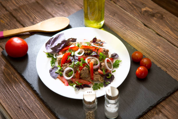 istock Fried liver with onion and tomatoes on black stone background 1069661816