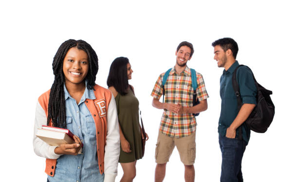 istock Female student smiling at camera with other students in background 1069664074