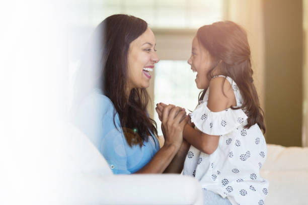 istock Mom and young daughter laugh together 1069664644