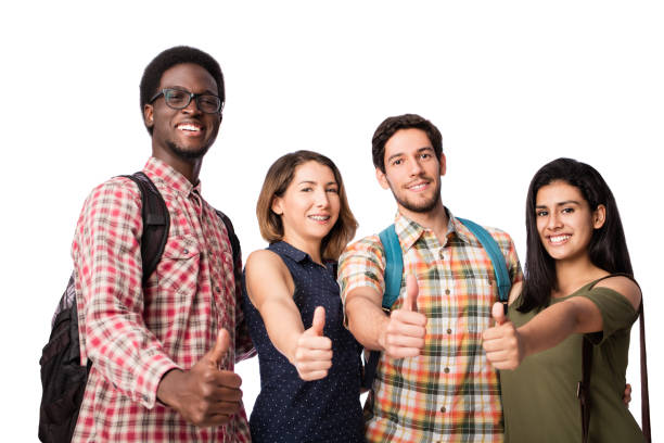 istock Four happy students giving thumbs up and looking at camera 1069664732