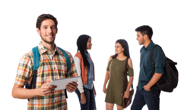 istock Male student standing with digital tablet and other students in background 1069665100