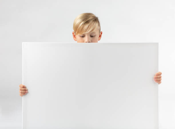 istock little blond boy holds a placard 1069668166