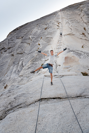 Athletic Hiker at the Cables climbing up the famous Half Dome, Yosemite National Park, California, USA. Nikon D850. Converted from RAW.