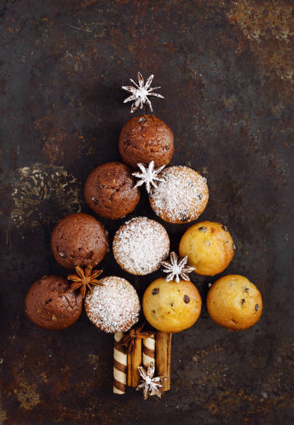 istock Assorted muffins in the shape of a Christmas tree on the old black rusty metal background. Top view. 1069672106