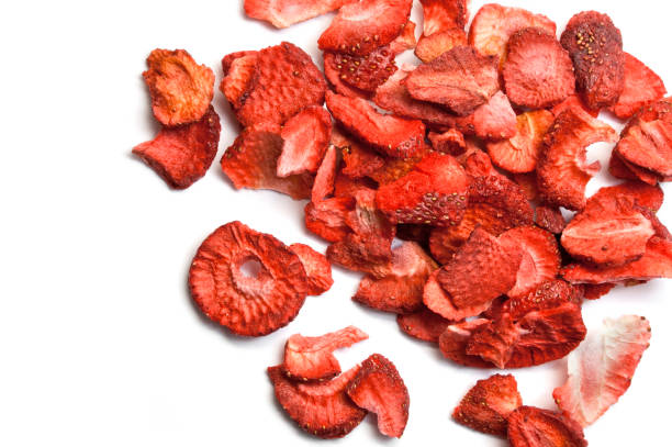 Sliced dried strawberries isolated on white Sliced dried strawberries isolated on white dried fruit on white stock pictures, royalty-free photos & images