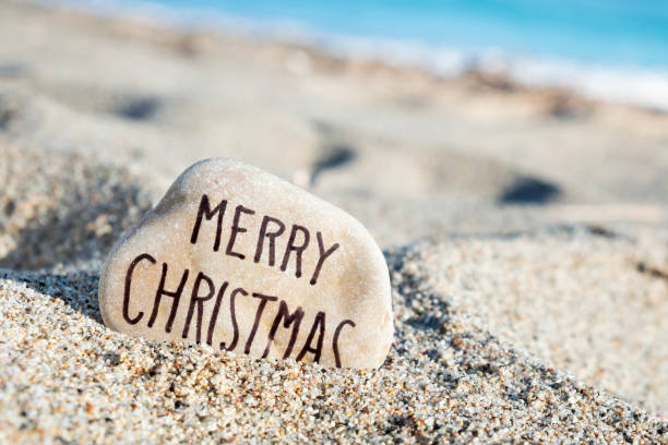 istock text merry christmas in a stone on the beach 1069675154