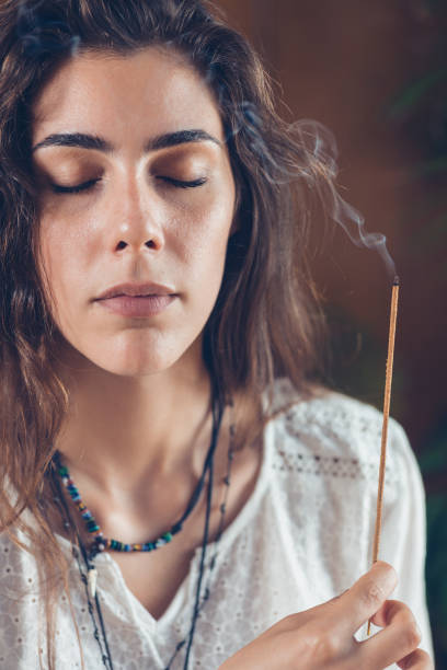 istock Meditation. Beautiful Young Woman Enjoying Incense Stick 1069679860