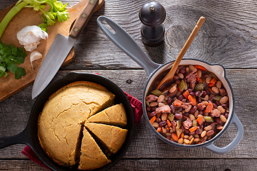 Cooking Ham and Bean Soup, with Cornbread in a Cast Iron Skillet