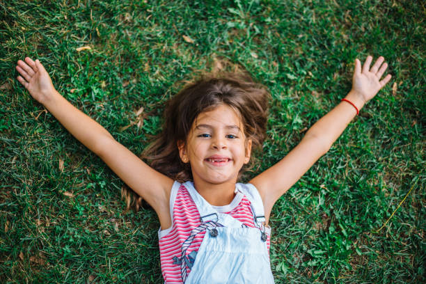 istock Happy Little girl resting on the grass 1069685266