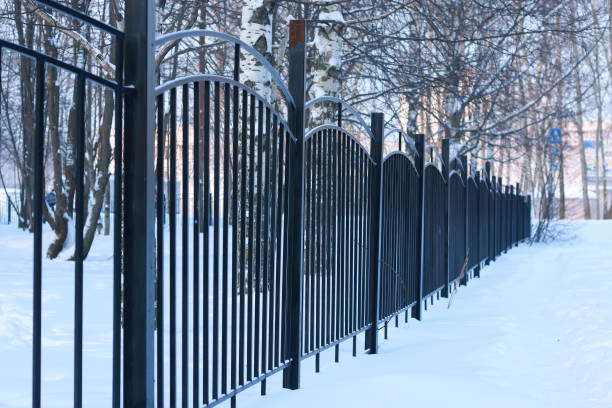 istock winter landscape iron fence at sunset 1069689206