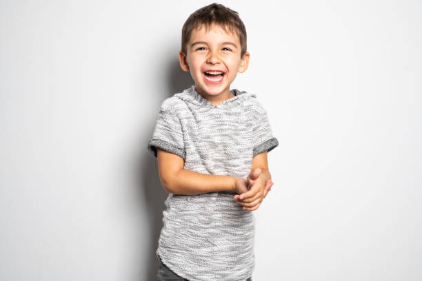Boy having fun on studio white background A Boy having fun on studio white background children laughing stock pictures, royalty-free photos & images