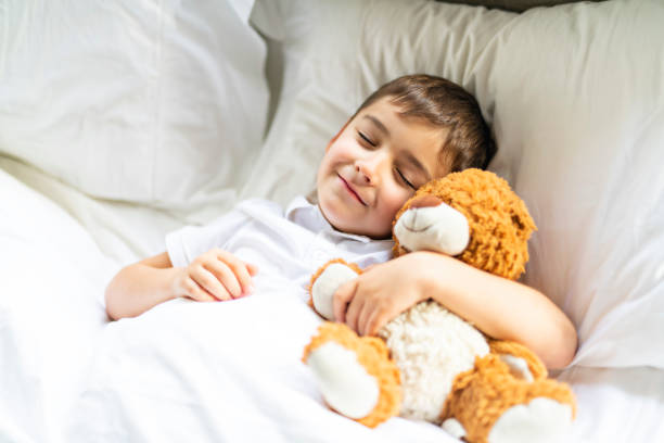 istock A little boy in bed sleeping and dreaming 1069693512