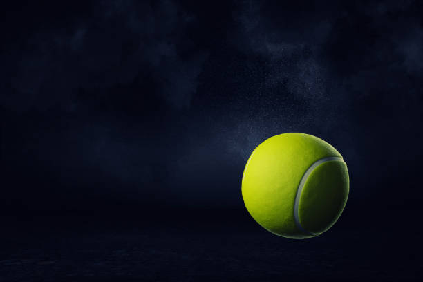 istock 3d rendering of a yellow tennis ball on a dark background. 1069695356