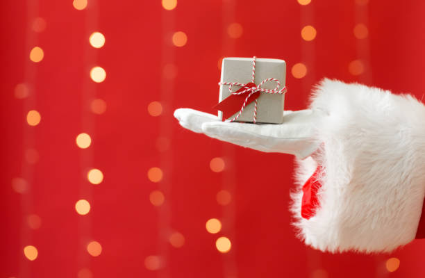 istock Santa holding a small Christmas gift 1069699652