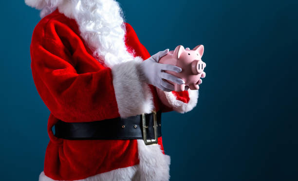 istock Santa holding a piggy bank 1069703402