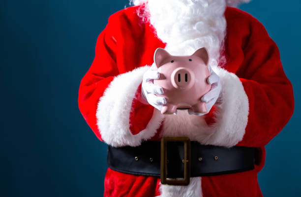 istock Santa holding a piggy bank 1069703426