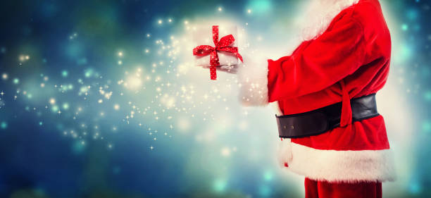 istock Santa holding a Christmas gift 1069703578