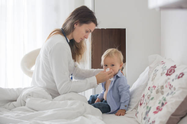 istock Young doctor, examiing sick baby boy on a home visitation 1069704812