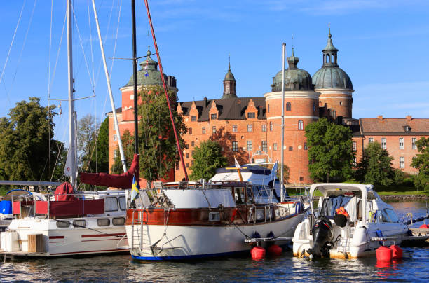 Boats in front of the Grisholm castle Mariefred, Sweden - August 18, 2018: Pleasure boats in front of the old red colored Gripsholm castle constructed during the 16th century. mariefred stock pictures, royalty-free photos & images