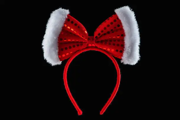 Red ribbon over tiara in shape of minnie mouse ears isolated.