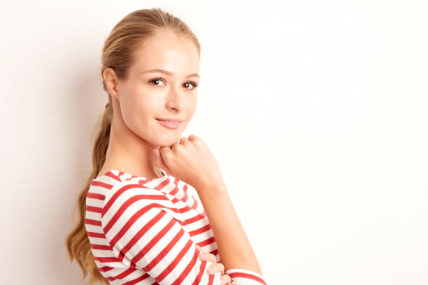 istock Smiling blond young woman studio portrait 1069707556