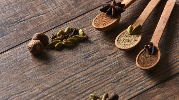 Cardamom, cloves, nutmeg, star anise, allspice. Different types of whole Indian spices in wooden background close-up. Healthy food. Cardamom, cloves, nutmeg, star anise, allspice. Different types of whole Indian spices in wooden background close-up. Healthy food salt pepper ingredient black peppercorn stock pictures, royalty-free photos & images