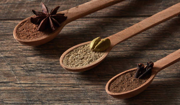 Cardamom, cloves, star anise. Ground spices in wooden spoons.Different types of whole Indian spices in wooden background close-up. Healthy food. Cardamom, cloves, nutmeg, star anise, allspice. Different types of whole Indian spices in wooden background close-up. Healthy food. salt pepper ingredient black peppercorn stock pictures, royalty-free photos & images