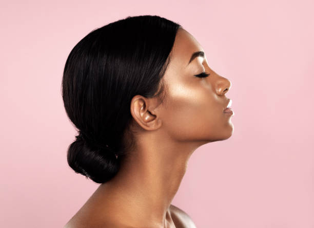 Perfection in profile Studio shot of a beautiful young woman posing with her eyes closed against a pink background skin care photos stock pictures, royalty-free photos & images