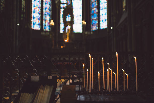 istock Lit Candles On Table In Church 1069717582