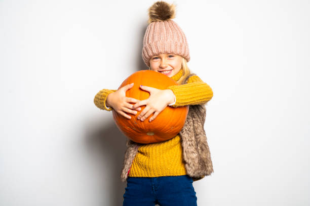 Cute girl 5 year old posing in studio on autumn season studio