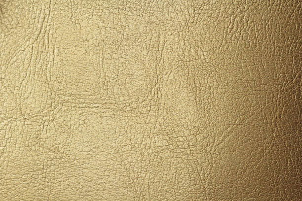 istock Gold or Bronze Natural Leather Background. Shiny yellow leaf gold foil texture background. Place for Text 1069718892