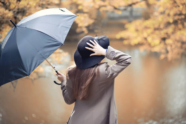istock Young girl in a coat in autumn  park 1069718954