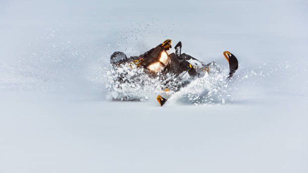 istock In deep powder snowdrift snowmobile rider make fast turn. 1069721958