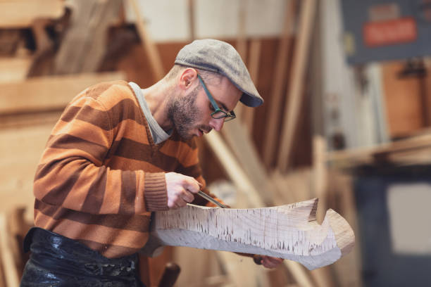 Carpenter working on wooden forcola for venetian gondola