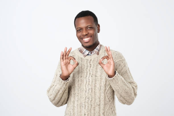 istock Cheerful young man in sweater gesturing OK sign. 1069722606