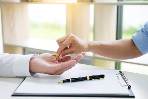 istock Hands Of Couple Holding Ring Over Clipboard 1069725182