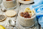 Overnight banana oats quinoa Chia seed pudding decorated with fresh banana slices and chocolate