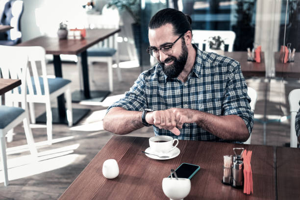 istock Successful busy businessman checking time while having meeting 1069730060
