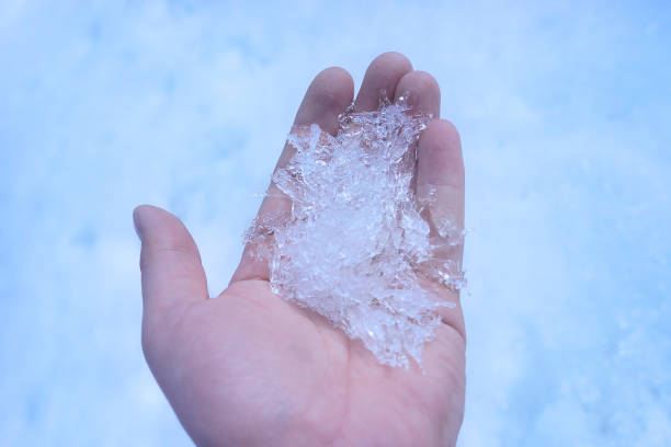 istock Hand holding snow crystals. Winter background. Tinted photo 1069731894
