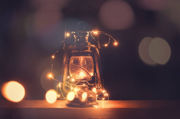 istock Vintage retro lantern with bokeh lights over dark background 1069734690