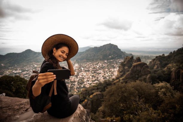 Selfie time. Argentinian woman traveling Mexico. She is making a self portrait latin american and hispanic culture photos stock pictures, royalty-free photos & images